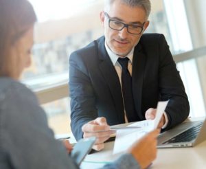 business man at his desk working with a client